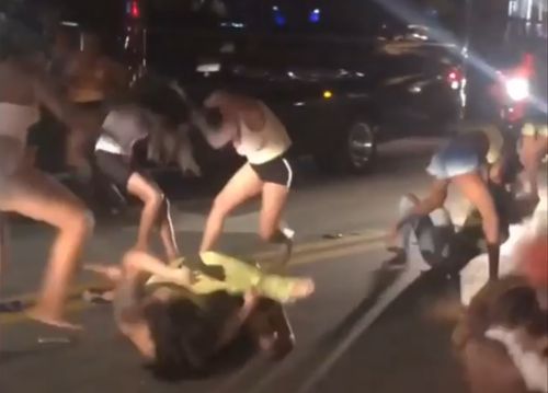 A bunch of women fighting in the middle of the street Photo 0001