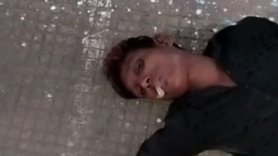 Man dying on the sidewalk with foam at the mouth somewhere in india Photo 0001 Video Thumb