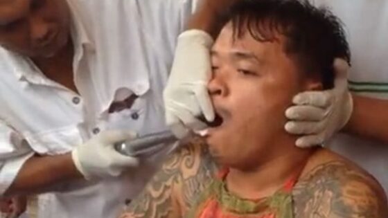 Man mouth impaled with metal spikes in thai festival Photo 0001 Video Thumb