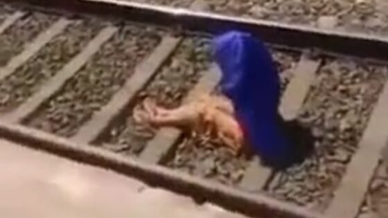 Woman rises from train tracks intact after being run over Photo 0001 Video Thumb