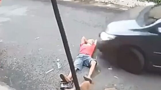 Man lying on the road crushed by a car Photo 0001 Video Thumb