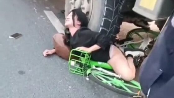 Cyclist is hit by a truck and leaves half of her body crushed by the tire as she writhes in pain Photo 0001 Video Thumb