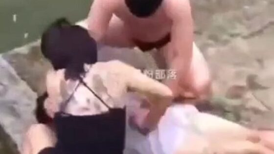 Chinese people trying to resuscitate an injured perhaps drowned woman in an innovative and extremely new way Photo 0001 Video Thumb