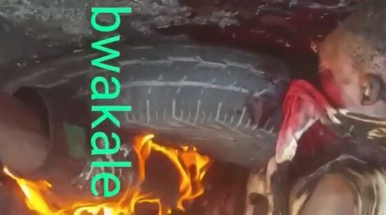 Man being burned alive amidst old tires in some african country Photo 0001 Video Thumb