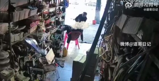 Man sitting in front of store has his head split in half by an ax in china Photo 0001 Video Thumb