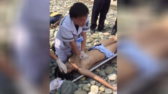 Rescuer trying to revive drowned girl in some asian country Photo 0001 Video Thumb