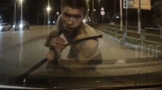 Russian man with a head full of drugs attacks car in the middle of the street as if he were a zombie Photo 0001 Video Thumb