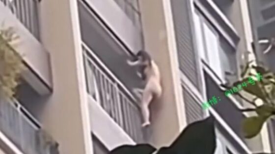 Undressed woman descends outside a high rise apartment building in china Photo 0001 Video Thumb