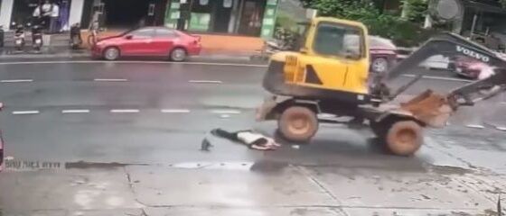 Woman run over by excavator in vietnam is left crushed on the asphalt Photo 0001 Video Thumb